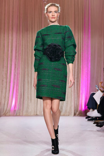 Nardos designed tweed dress with long sleeves and high neckline, complimented with a large black satin rose belt