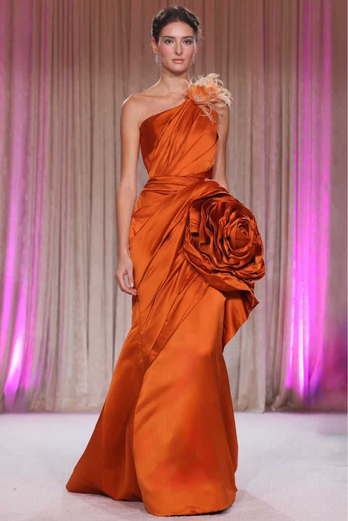 Nardos designed gown sashaying with fiery elegance and bold hue and sculptural rosette, embodying a fusion
of artistry and allure