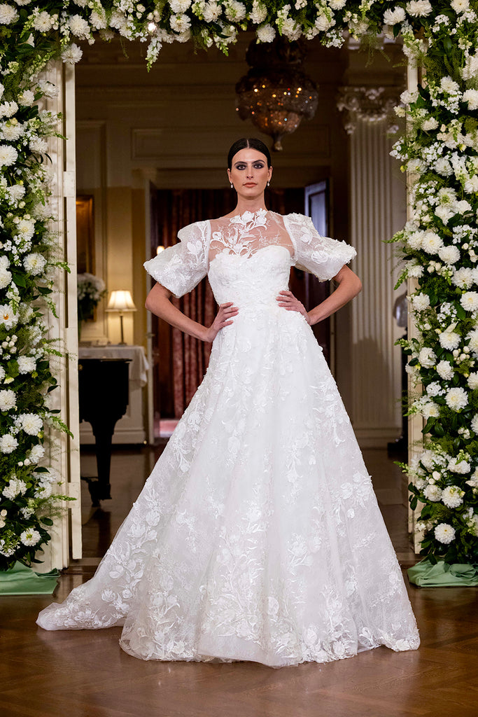 Nardos designed luxury bridal gown - Dallas, TX and New York, NY. Floral embroidered sweetheart A-line dress with a puff sleeve topper.