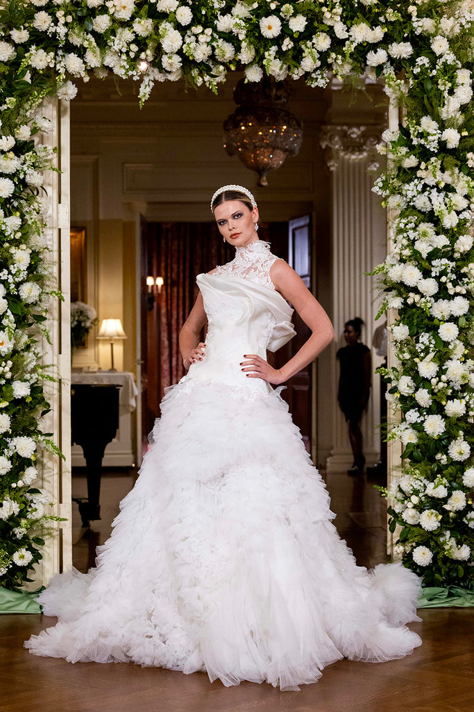 Nardos designed luxury bridal gown - Dallas, TX and New York, NY. Flowing bodice design with a drop waist a-line gown with a flowing skirt and a lacy halter neck.