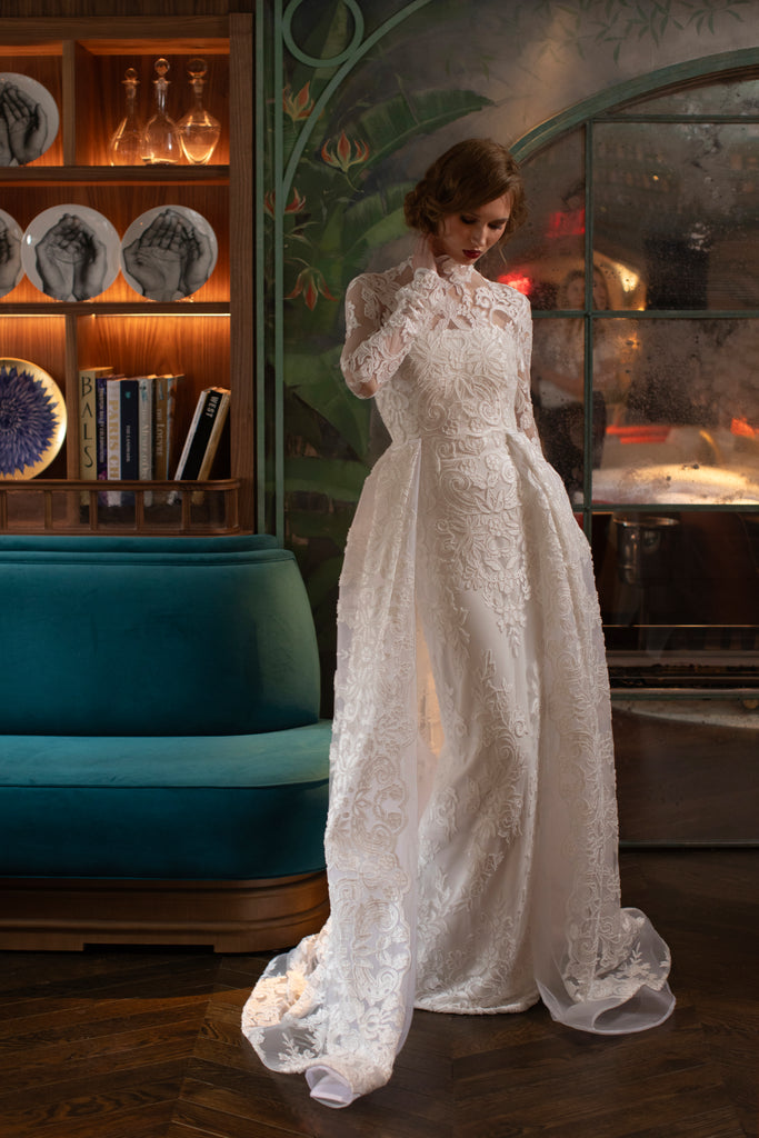 Nardos designed floral beaded long sheer long sleeves and white column styled gown with a beaded lace train.