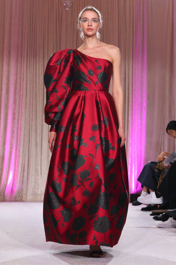 Nardos designed draped one shoulder gown with a bold floral elegance, encapsulating a modern twist on romantic opulence.